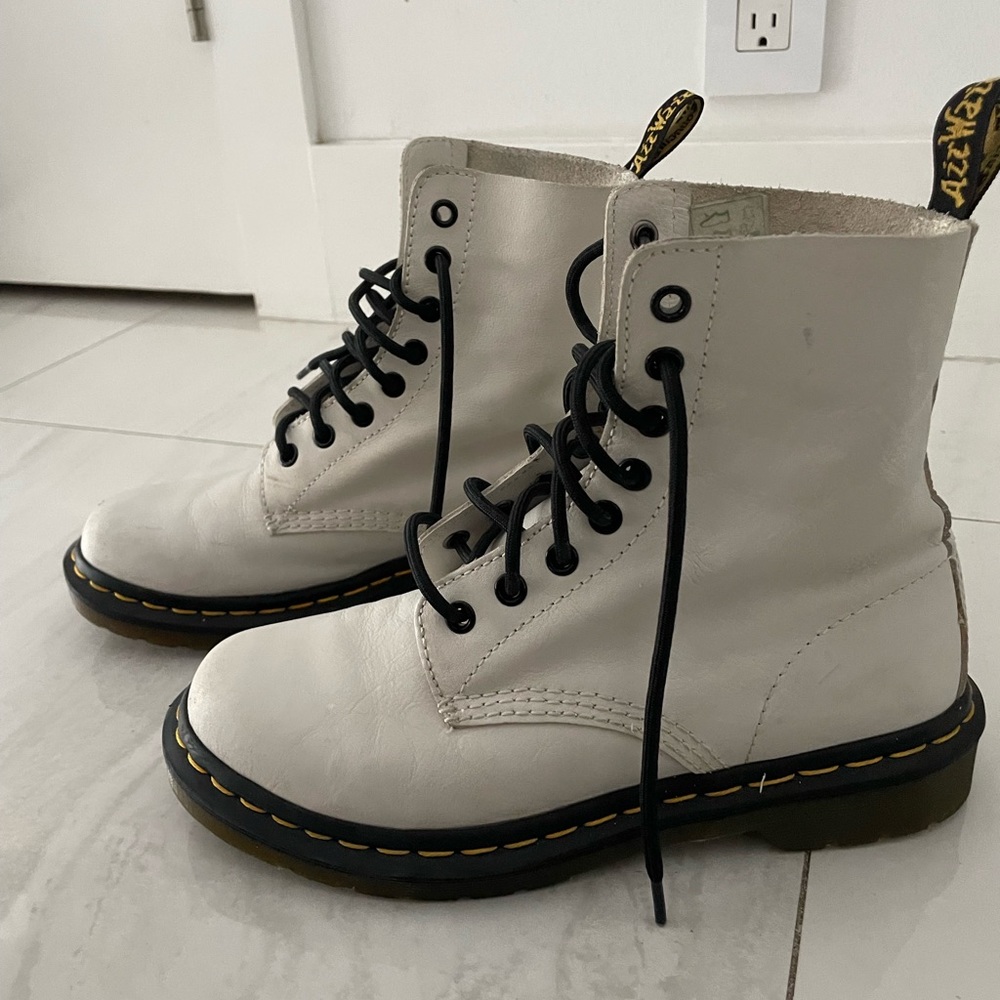 Dr martens white with black lashes.
